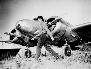 Amelia Earhart, who served as a consultant in the Department of the Study of Careers for Women at Purdue from 1935 to 1937, strides past her Lockheed Electra. Sally Putnam Chapman has donated 492 Earhart items Ñ including rarely seen personal and private papers such as poems, a flight log and a prenuptial agreement Ñ to Purdue Libraries' Earhart collection. (File photo) A publication-quality photograph is available at ftp://ftp.purdue.edu/pub/uns/earhart.newdocs/earhart.electra.jpeg.
